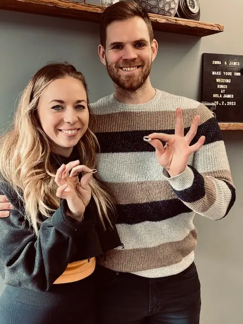 Emma and James holding the wedding rings they made at Orla James
