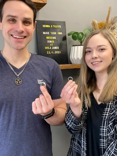 Gemma and Travis holding the wedding rings they made at Orla James