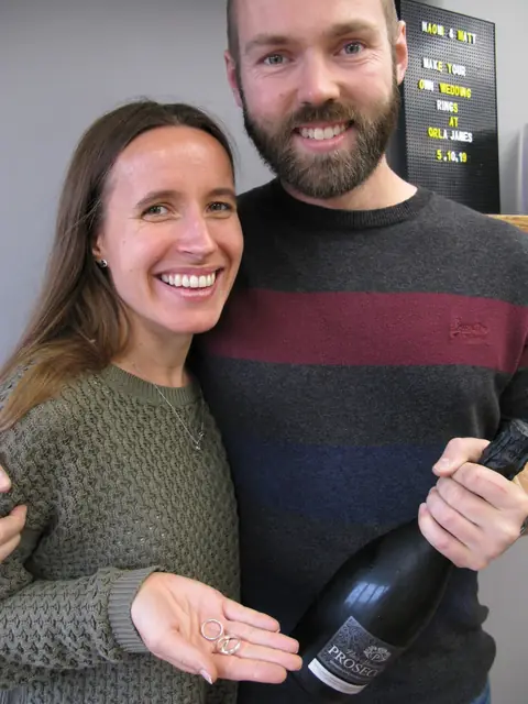 Naomi and Matt holding the wedding rings they made at Orla James