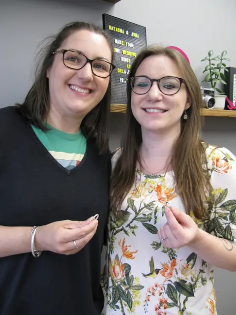 Natasha and Anna holding the wedding rings they made at Orla James
