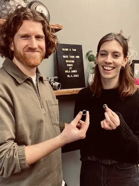 Niamh and Tom holding the wedding rings they made at Orla James