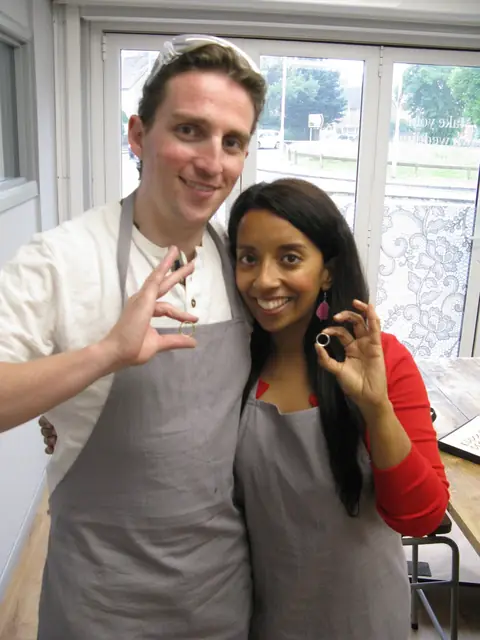 Shofna and Steve holding the wedding rings they made at Orla James