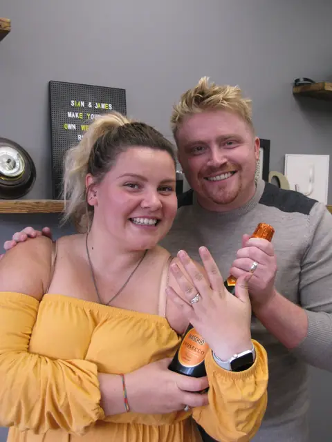 Sian and James holding the wedding rings they made at Orla James