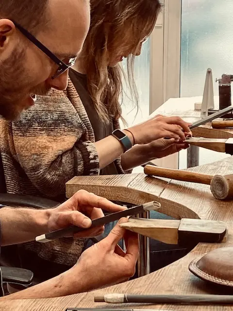 A couple working side by side at the Orla James jewellery bench