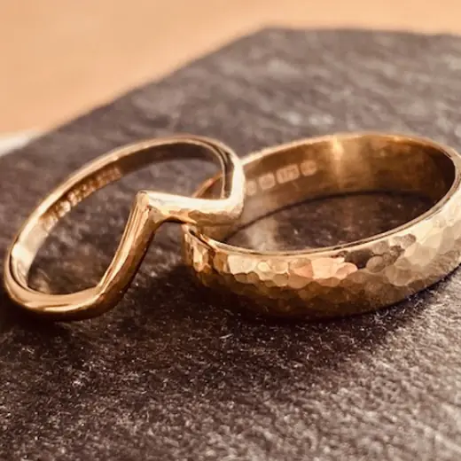 Shaped wedding band made to sit around an engagement ring
